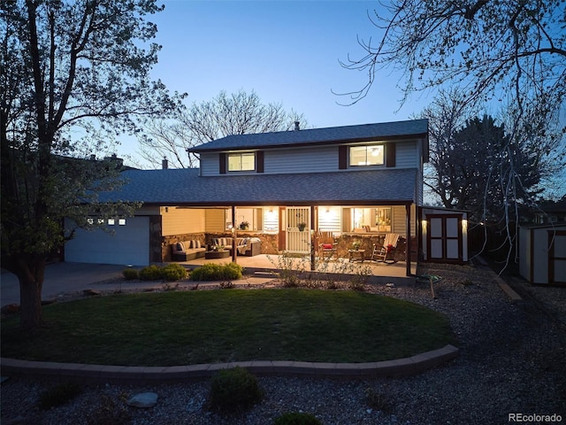 view of front of house with an outdoor structure, a garage, a front lawn, an outdoor hangout area, and a storage shed