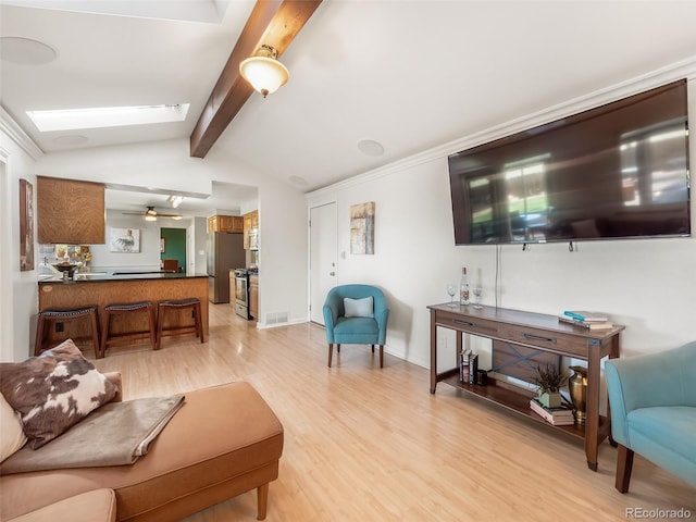 living area with baseboards, visible vents, light wood-type flooring, and lofted ceiling with skylight