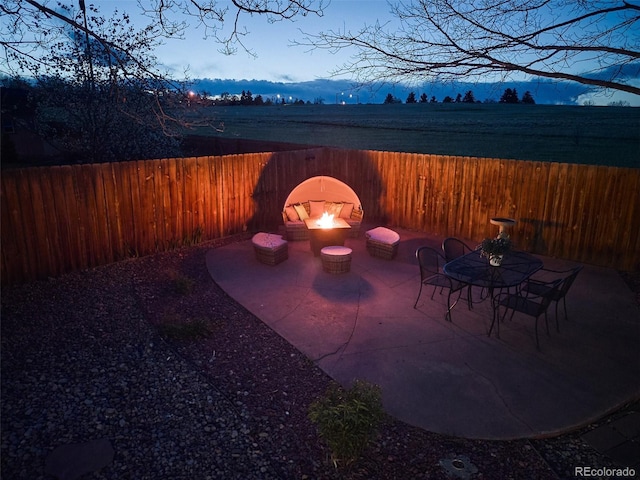 view of patio / terrace with fence and an outdoor fire pit