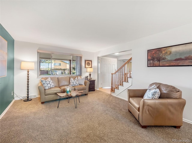 carpeted living area with baseboards and stairs