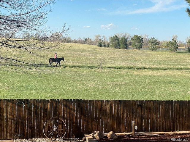 view of yard featuring fence and a rural view