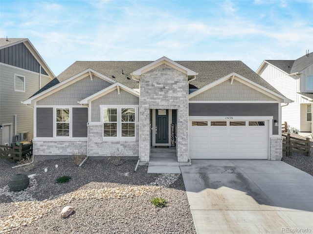 craftsman inspired home with a garage, stone siding, roof with shingles, and concrete driveway