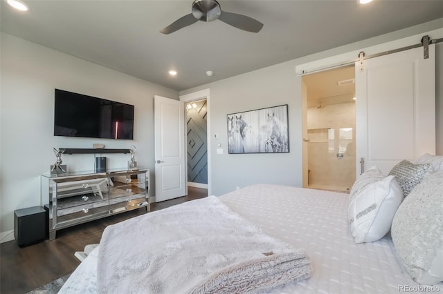 bedroom with recessed lighting, a barn door, baseboards, and wood finished floors