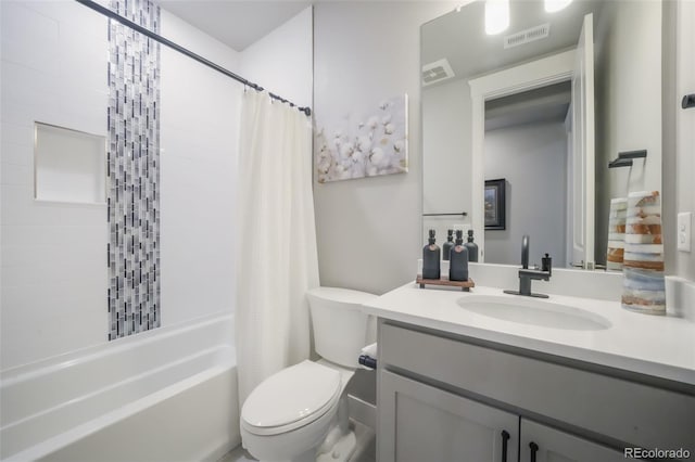 bathroom with visible vents, shower / bath combo, vanity, and toilet