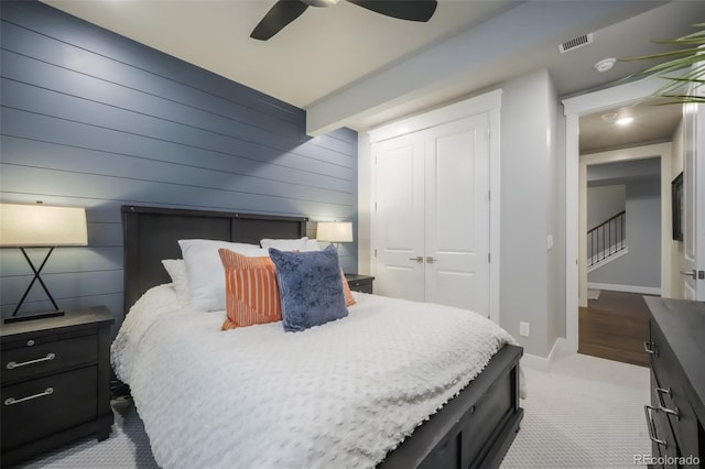 carpeted bedroom with baseboards, visible vents, ceiling fan, and a closet