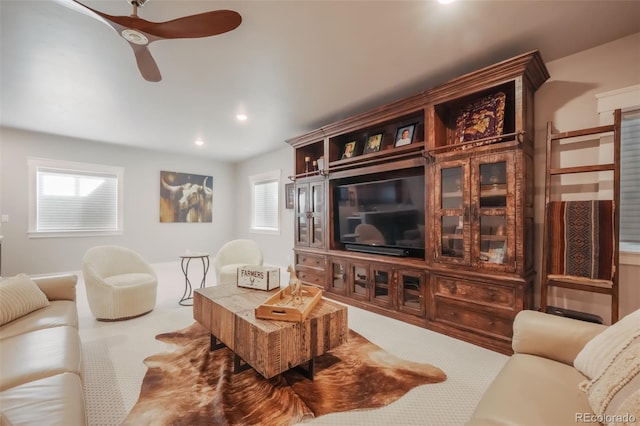 living area featuring carpet floors, a wealth of natural light, recessed lighting, and a ceiling fan