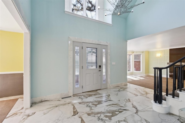 foyer with a chandelier and a high ceiling