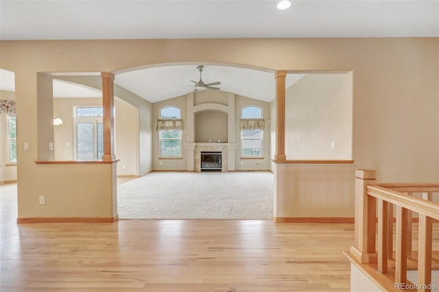 16231 Rayburn St, Hudson, CO 80642 - unfurnished living room featuring a ceiling fan, wood finished floors, arched walkways, lofted ceiling, and baseboards