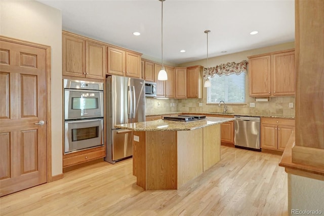 16231 Rayburn St, Hudson, CO 80642 - kitchen featuring appliances with stainless steel finishes, light brown cabinetry, light wood-type flooring, light stone countertops, and decorative backsplash