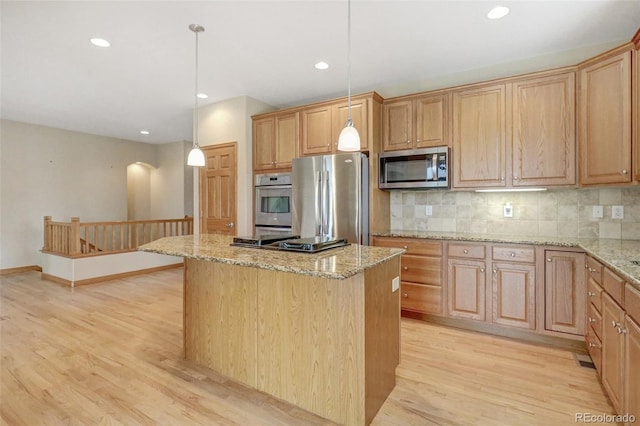 16231 Rayburn St, Hudson, CO 80642 - kitchen featuring stainless steel appliances, light wood-style floors, a center island, tasteful backsplash, and recessed lighting