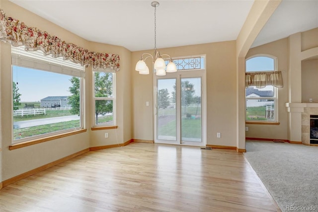 16231 Rayburn St, Hudson, CO 80642 - unfurnished dining area with a chandelier, healthy amount of natural light, wood finished floors, and baseboards