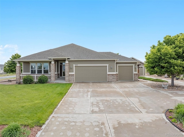 16231 Rayburn St, Hudson, CO 80642 - prairie-style home featuring an attached garage, a front yard, driveway, brick siding, and a shingled roof