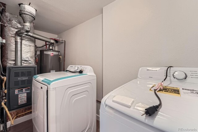 1533 E Harlan, Lakewood, CO 80214 - laundry room with water heater, washing machine and clothes dryer, and wood finished floors
