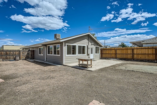 1533 E Harlan, Lakewood, CO 80214 - back of house with a fenced backyard, a patio area, and cooling unit