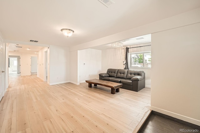 1533 E Harlan, Lakewood, CO 80214 - living room featuring baseboards and light wood-type flooring