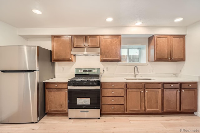 1533 E Harlan, Lakewood, CO 80214 - kitchen featuring stainless steel appliances, a sink, under cabinet range hood, light countertops, and recessed lighting