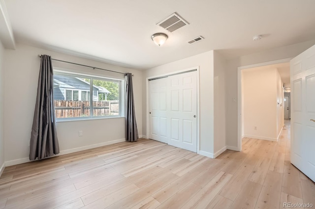 1533 E Harlan, Lakewood, CO 80214 - unfurnished bedroom featuring light wood finished floors, a closet, and baseboards