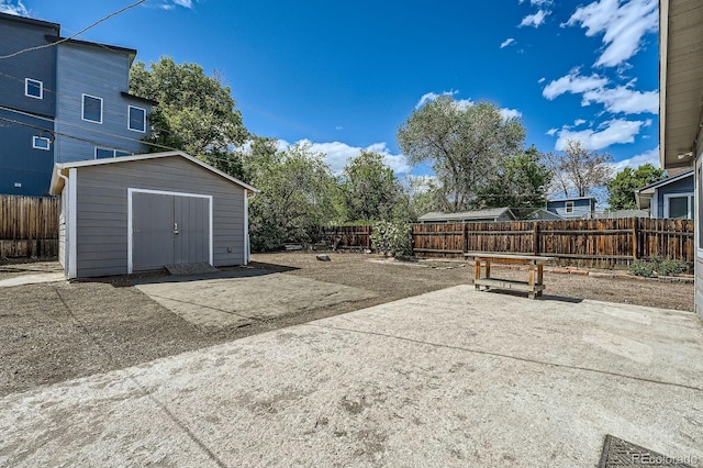 1533 E Harlan, Lakewood, CO 80214 - view of patio featuring a shed, a fenced backyard, and an outdoor structure