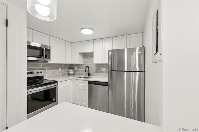 kitchen with white cabinetry, sink, and appliances with stainless steel finishes