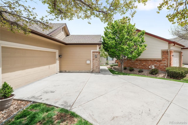 6193 Terry Ct, Arvada, CO 80403 - view of front of house with concrete driveway, brick siding, and a garage