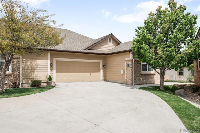 6193 Terry Ct, Arvada, CO 80403 - view of front of home featuring concrete driveway, an attached garage, brick siding, and roof with shingles
