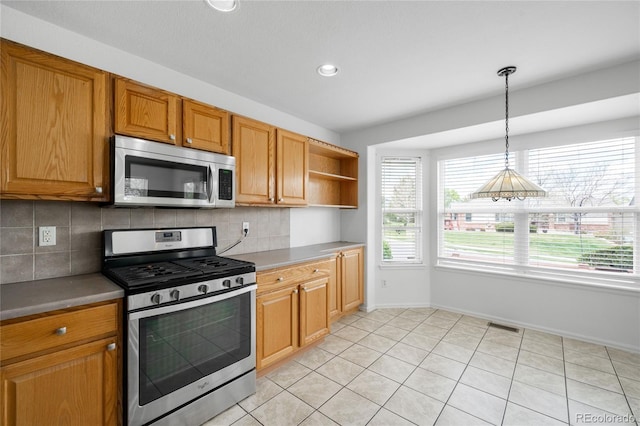 6193 Terry Ct, Arvada, CO 80403 - kitchen with appliances with stainless steel finishes, decorative backsplash, baseboards, open shelves, and decorative light fixtures