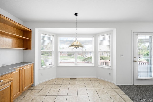 6193 Terry Ct, Arvada, CO 80403 - unfurnished dining area with plenty of natural light, light tile patterned floors, and baseboards