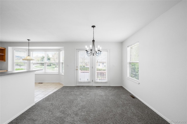 6193 Terry Ct, Arvada, CO 80403 - unfurnished dining area with a chandelier, light colored carpet, plenty of natural light, and baseboards