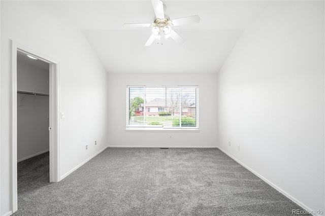 6193 Terry Ct, Arvada, CO 80403 - unfurnished bedroom with a spacious closet, carpet floors, vaulted ceiling, baseboards, and ceiling fan