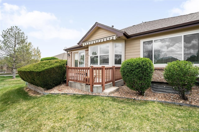 6193 Terry Ct, Arvada, CO 80403 - rear view of property featuring a lawn and a deck