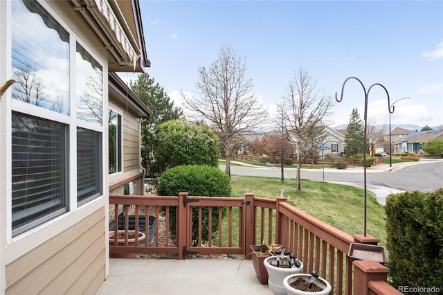 6193 Terry Ct, Arvada, CO 80403 - wooden terrace with a porch, a residential view, and a yard