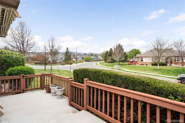 6193 Terry Ct, Arvada, CO 80403 - wooden deck with a residential view, a lawn, and covered porch