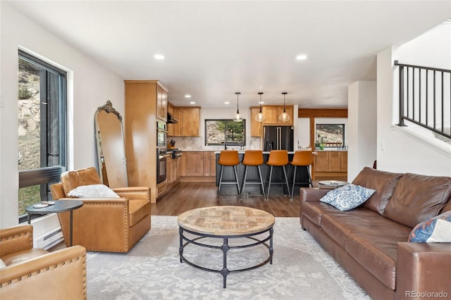 6640 Kilimanjaro Dr, Evergreen, CO 80439 - living area with recessed lighting, a baseboard heating unit, and light wood-style flooring