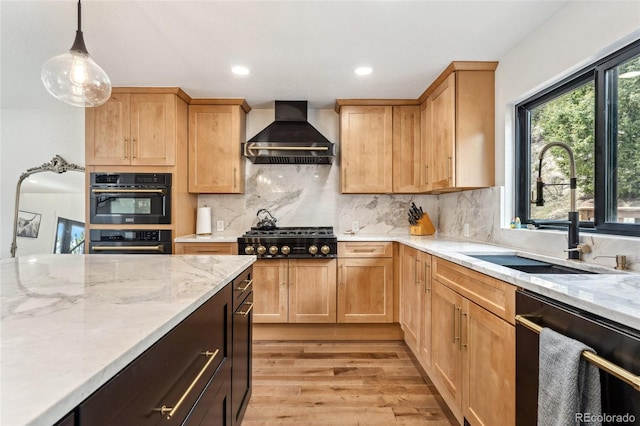 6640 Kilimanjaro Dr, Evergreen, CO 80439 - kitchen featuring light stone countertops, wall chimney exhaust hood, a sink, light wood-style flooring, and black appliances