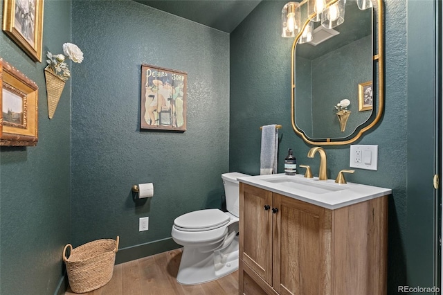 6640 Kilimanjaro Dr, Evergreen, CO 80439 - bathroom with vanity, a textured wall, wood finished floors, and toilet