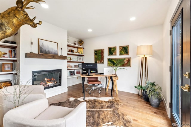 6640 Kilimanjaro Dr, Evergreen, CO 80439 - office space featuring recessed lighting, baseboards, a glass covered fireplace, and wood finished floors