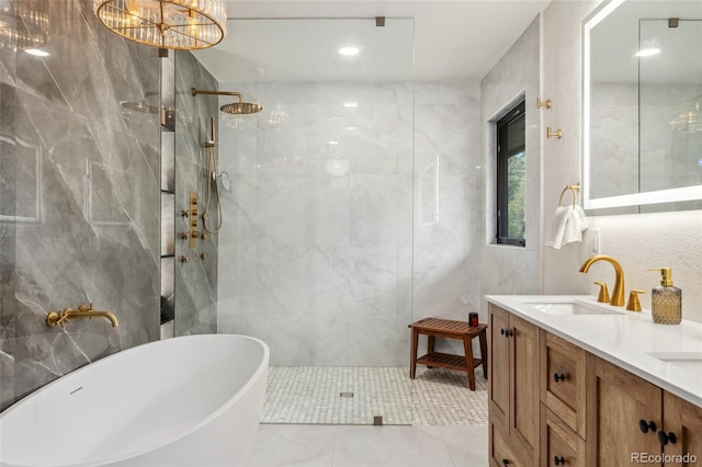 6640 Kilimanjaro Dr, Evergreen, CO 80439 - bathroom with double vanity, tile walls, a freestanding tub, a sink, and a marble finish shower