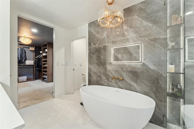 6640 Kilimanjaro Dr, Evergreen, CO 80439 - full bath featuring an inviting chandelier, tile walls, a soaking tub, and a spacious closet