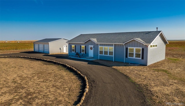 6 Timberlake Ct, Byers, CO 80103 - ranch-style home with a garage, board and batten siding, an outdoor structure, and a shingled roof