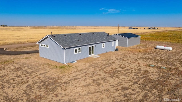 6 Timberlake Ct, Byers, CO 80103 - back of property featuring a view of countryside, an outbuilding, a shingled roof, and entry steps