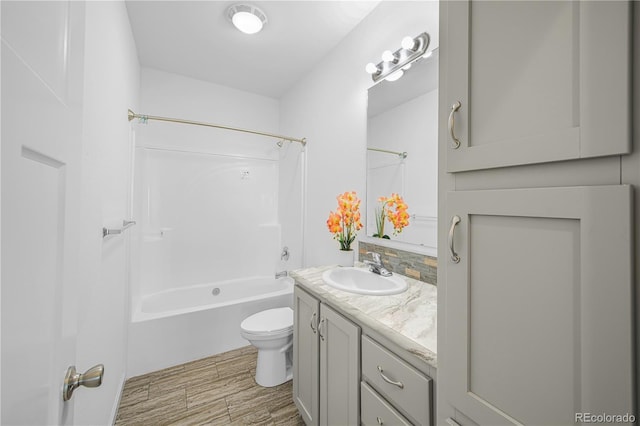 6 Timberlake Ct, Byers, CO 80103 - bathroom with vanity, toilet, shower / washtub combination, wood finished floors, and tasteful backsplash