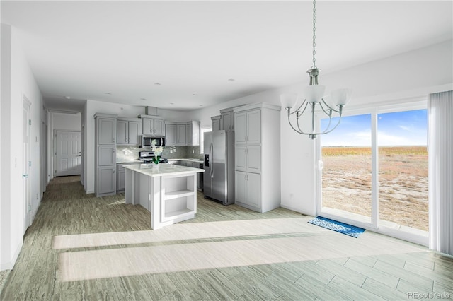 6 Timberlake Ct, Byers, CO 80103 - kitchen with appliances with stainless steel finishes, gray cabinets, a chandelier, and open shelves