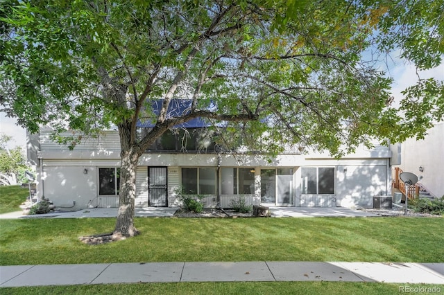 ranch-style house with a front lawn and a patio