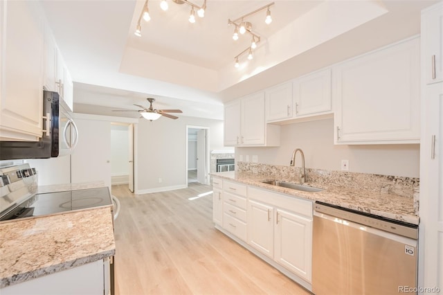 kitchen featuring light hardwood / wood-style flooring, white cabinetry, sink, and stainless steel appliances