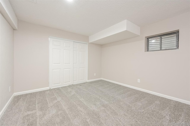 unfurnished bedroom with a textured ceiling, light colored carpet, and a closet