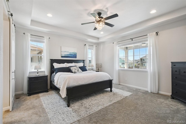 171 S Waterloo St, Aurora, CO 80018 - bedroom with light carpet, multiple windows, a tray ceiling, recessed lighting, and a ceiling fan