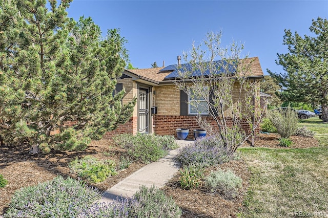 2901 N Glencoe St, Denver, CO 80207 - view of front facade featuring brick siding and roof mounted solar panels