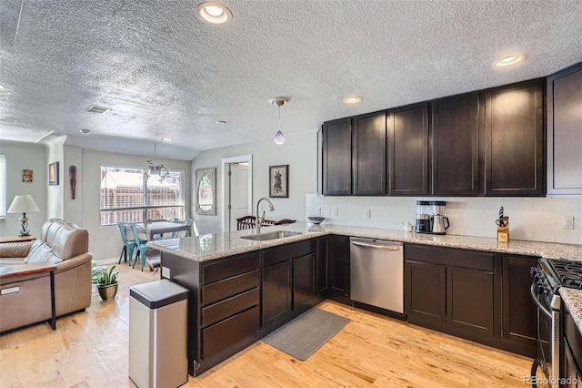 2901 N Glencoe St, Denver, CO 80207 - kitchen with appliances with stainless steel finishes, a sink, a textured ceiling, dark brown cabinetry, and open floor plan