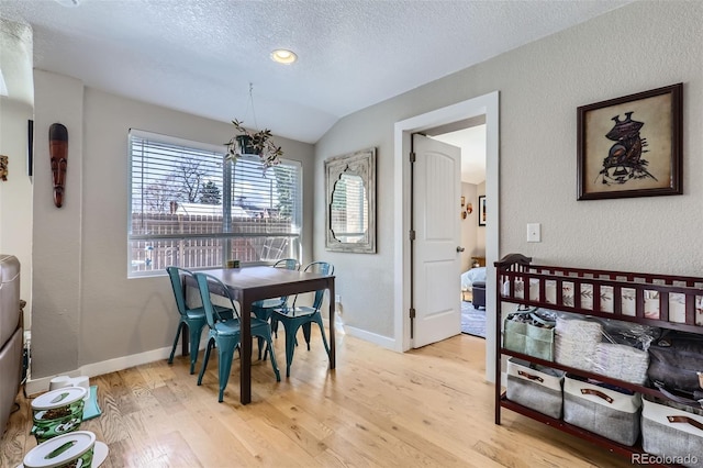 2901 N Glencoe St, Denver, CO 80207 - dining space with light wood finished floors, a textured ceiling, baseboards, a textured wall, and lofted ceiling
