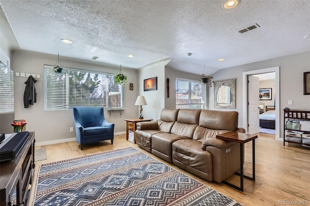 2901 N Glencoe St, Denver, CO 80207 - living room featuring wood finished floors, a textured ceiling, baseboards, and recessed lighting